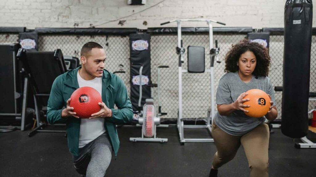 Personal Trainer Exercising with Client