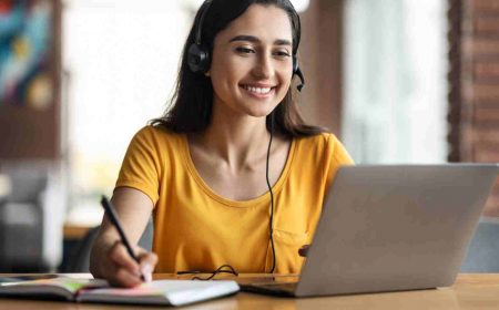 Woman on Laptop Researching Accreditation for Nutrition Courses