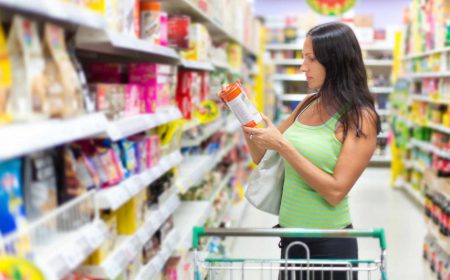 Woman in Shop Reading Food Labels